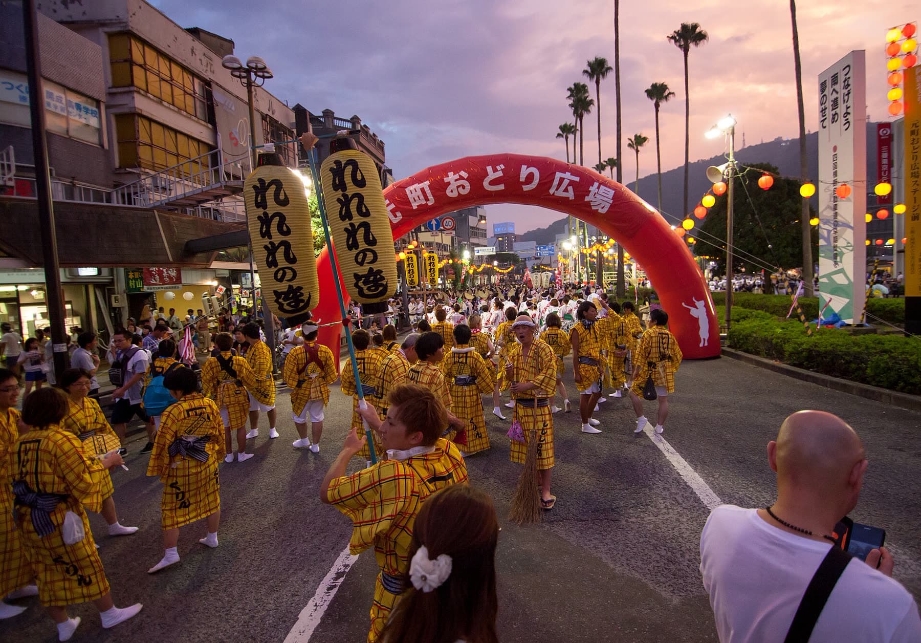 Dancers in yellow happi coats at the Awa Odori festival in Tokushima at dusk